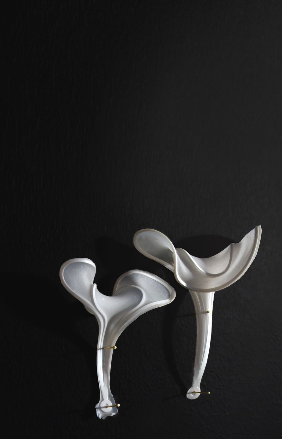 White material and texture samples resembling a mushroom on a black background.