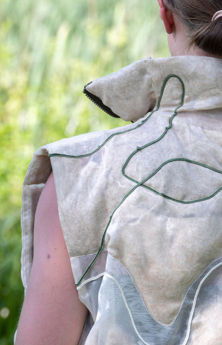 Transparent vest filled with Fluff Stuff on a person in nature.
