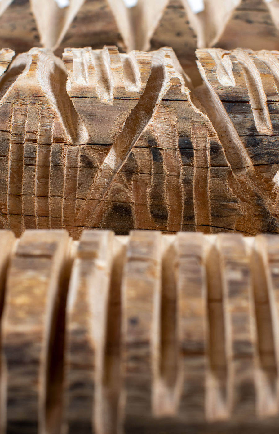 Carved details of an acoustic panel made from waste wood.