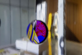 Peak of a colourful animation inside the reflective info structure.