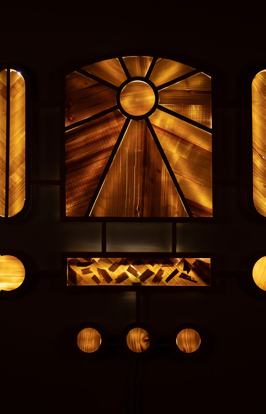 Wood Shrine, wooden light panel, on on a black background.